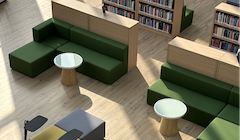 A student learning place with two seating booths with work tables, and book shelves behind the booths.