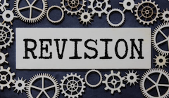 Interlocking gears surrounding the word "revision".